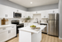 Modern, elegant kitchen with sleek white cabinetry, stainless steel appliances, and a spacious marble-topped island, perfect for culinary enthusiasts.
