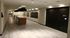 Modern apartment corridor with sleek wooden flooring, stylish lighting, and a convenient package concierge service.