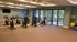 Modern fitness room with stationary bikes, full-length mirrors, and large windows offering natural light.