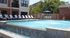 Inviting outdoor pool area with sleek lounge chairs and elegant water features, perfect for relaxation and enjoyment.