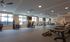 Spacious modern gym with state-of-the-art fitness equipment, featuring large windows for natural light and sleek design.