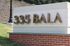 Elegant signage of '335 BALA' showcasing a modern design with lush surroundings.