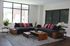 Modern and inviting living room with large windows, stylish gray couches adorned with vibrant pink cushions, and chic wooden accents, creating a cozy retreat.