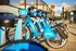 Vibrant city scene featuring a row of bright blue Indego bikes ready for an adventurous urban ride.