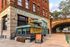 Charming corner brewery with vibrant outdoor seating, featuring lively signage and a rustic urban vibe.