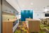 Bright and modern open-concept kitchen with sleek wooden countertops, colorful geometric flooring, and elegant lighting.