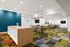 Contemporary open-concept apartment space featuring vibrant patterned flooring, modern lounge area, and sleek dining space with stylish pendant lighting.