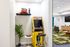 Chic entertainment corner with a vibrant Pac-Man arcade game, comfy seating, and a lively carpet design, perfect for a playful retreat.