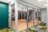 Modern fitness center with glass walls, featuring state-of-the-art gym equipment and stylish decor.