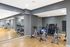 Modern fitness room with bikes, weights, and exercise equipment, ideal for active living.
