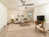 Bright and spacious living room featuring modern furniture, elegant decor, and a large window bringing in natural light.
