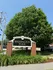 Charming entrance sign for Washington Park framed by lush greenery and a clear blue sky.