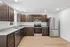Modern kitchen featuring sleek stainless steel appliances, elegant dark wood cabinets, and pristine granite countertops.