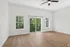 Bright and airy room featuring elegant wood floors, large windows, and a glass door opening to a scenic balcony view.