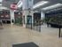 Inviting atrium-style apartment complex with lush greenery, brick walls, and abundant natural light.
