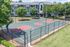 Inviting outdoor basketball court within a lush apartment complex, showcasing vibrant greenery and modern living amenities.