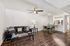 Chic open-concept living area featuring a cozy leather sofa, elegant glass coffee table, and stylish dining setup adjacent to a modern kitchen.