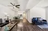 Chic open-plan living area featuring sleek hardwood floors, modern furniture, and a cozy atmosphere, leading into a contemporary kitchen.