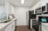 Sleek modern kitchen with stainless steel appliances, gleaming countertops, and elegant cabinetry, perfect for culinary creativity.