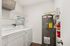Convenient laundry room equipped with modern washer, dryer, and ample shelving space, perfect for efficient home living.