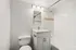 Elegant bathroom with modern vanity, sleek fixtures, and calming neutral tiles creating a serene atmosphere.
