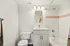 Bright and modern bathroom featuring sleek white fixtures, elegant vanity, and comfortable bathtub for relaxation.