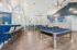 Elegant community recreation room featuring a sleek billiards table, modern bar seating, and vibrant decor with mounted TV screens.