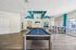 Chic recreation room with a modern pool table, elegant flooring, and vibrant blue accents creating a welcoming social atmosphere.