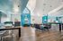 Bright and modern lounge area with sleek furnishings, high ceilings, and vibrant blue accents, ideal for relaxation and community gatherings.
