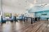 Bright and modern community lounge with high ceilings, sleek seating areas, and natural light, perfect for social gatherings.