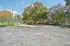 Inviting fenced sand area surrounded by lush greenery, perfect for outdoor activities and relaxation.