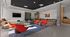 Contemporary lounge with vibrant seating, sleek decor, and natural light, perfect for relaxation or social gatherings.