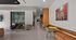 Modern communal mezzanine space with stylish seating, vibrant artwork, and sleek design elements, ideal for relaxation and collaboration.