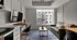 Chic urban studio with modern decor, featuring a cozy sofa, sleek table, large window with city view, and a mounted flat-screen TV.