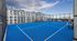 Vibrant rooftop tennis court with stunning cityscape backdrop, perfect for active urban living.