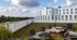 Stunning rooftop terrace with modern outdoor seating, lush greenery, and panoramic views of the city skyline.