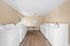 Bright and spacious laundry room featuring multiple washers and dryers, complemented by natural light and a clean design.