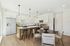 Open living room  and kitchen with large windows and designer finishes.