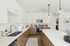 Open living room  and kitchen with large windows and designer finishes.