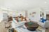 Open living room  and kitchen with large windows and designer finishes.
