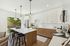 Open living room  and kitchen with large windows and designer finishes.