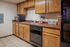 Inviting kitchen with wooden cabinets, modern appliances, and tile flooring.