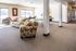 Inviting open living area with floral couches, large windows, and a table for gatherings.