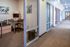 Bright hallway displaying a cozy corner office space with modern decor.