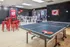 Stylish recreational space featuring a ping pong table and modern seating with Wisconsin-themed decor.