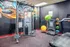 Colorful home gym featuring modern fitness equipment and vibrant wall art.