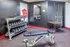 Contemporary gym area with sleek dumbbell rack and adjustable bench, ideal for workout enthusiasts.