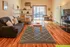 Charming studio apartment with open layout, featuring cozy living area, modern shelving, and a bright workspace by large sliding doors.