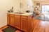 Inviting open-plan apartment with a cozy living area, stylish kitchen island, and warm wooden floors.