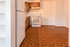Charming kitchen with warm tones, featuring classic wooden cabinetry and a pristine white oven for a cozy cooking space.